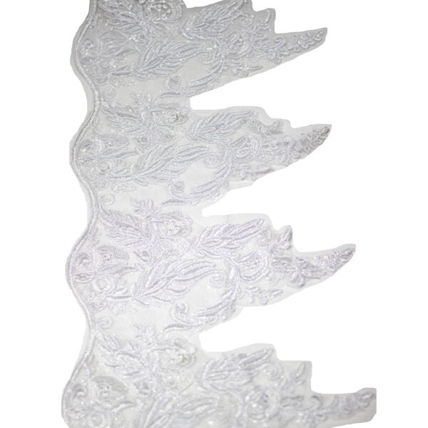 Decorative white dress art with floral patterns on a white background