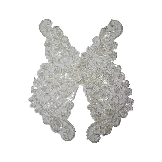Decorative lace piece with intricate patterns on a white background