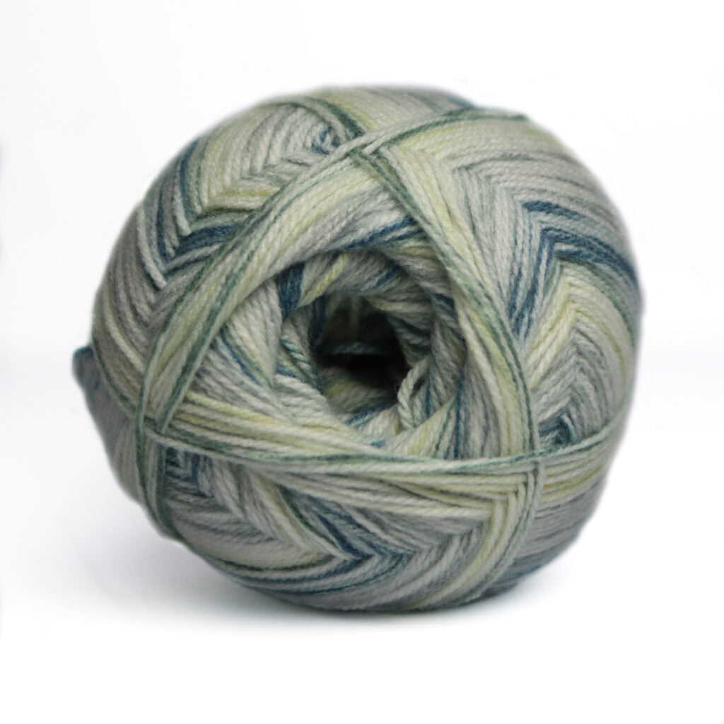 Ball of yarn with green and blue pattern on a white background